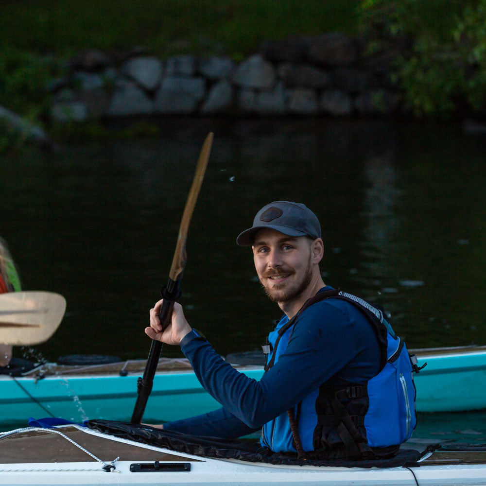 Emil Gyllenberg paddling a kayak and smiling