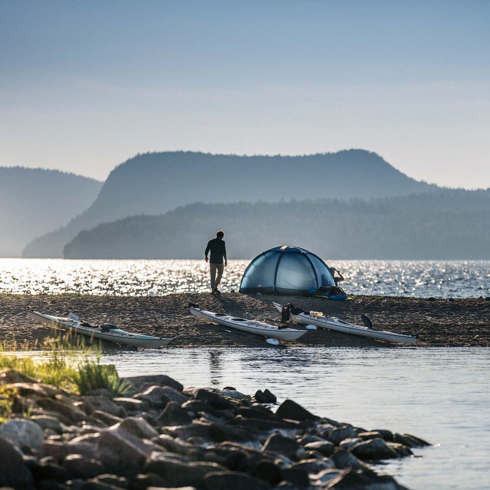 Melker väderö kayak and tents on a beach in the high coast in Sweden